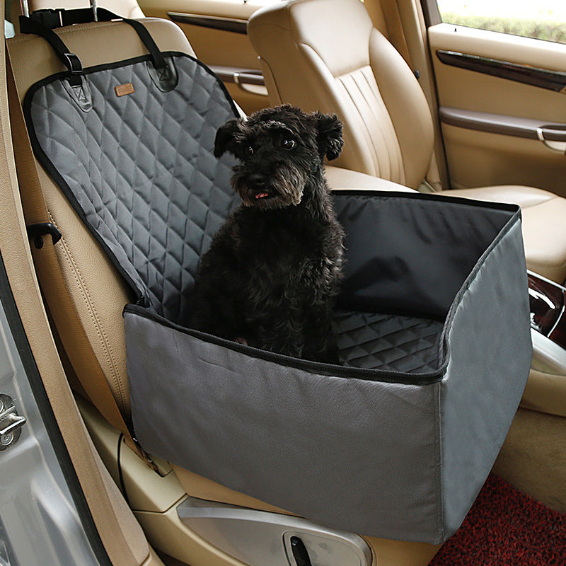 Dog sitting in a car seat cover inside a vehicle