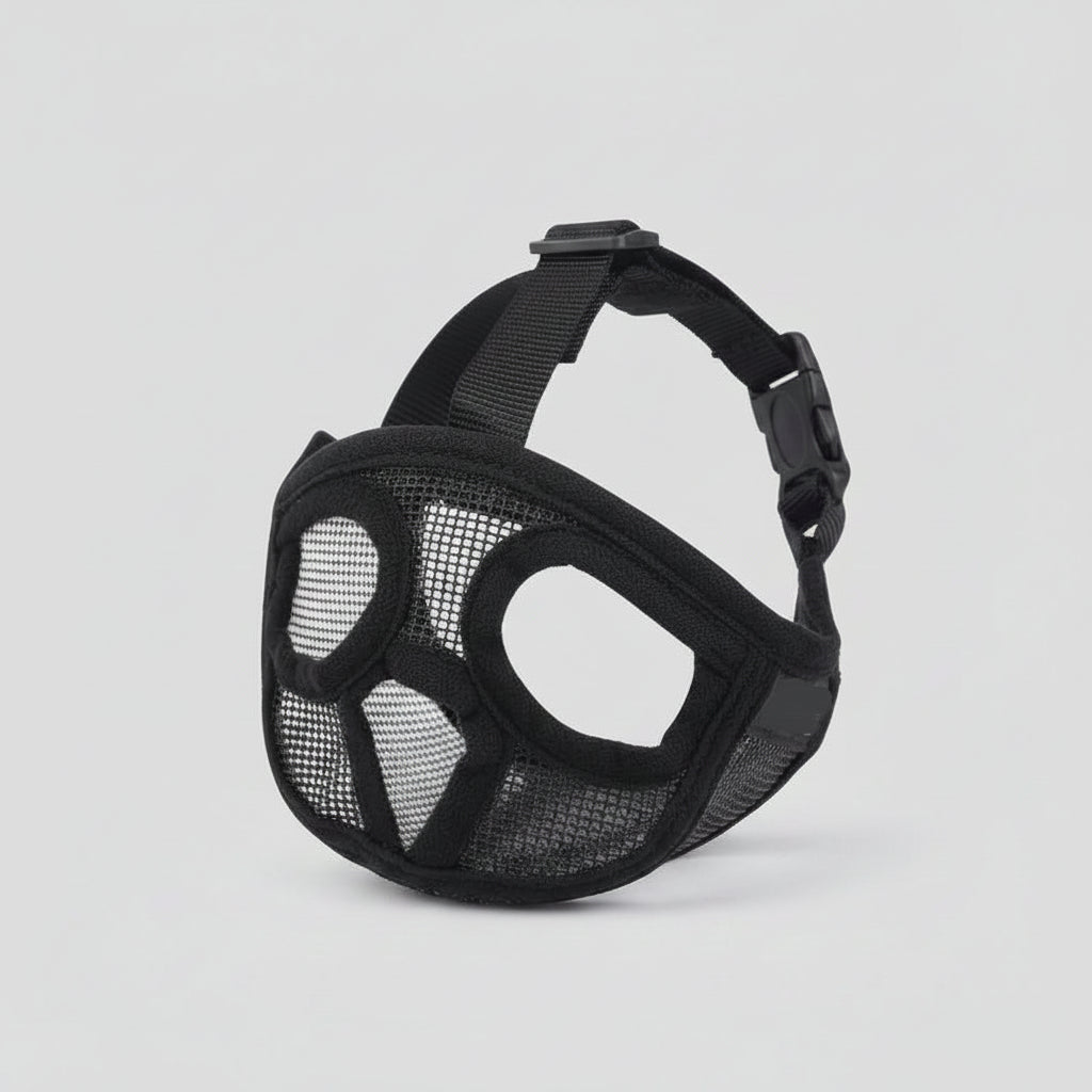 Black mesh dog muzzle with straps on a white background