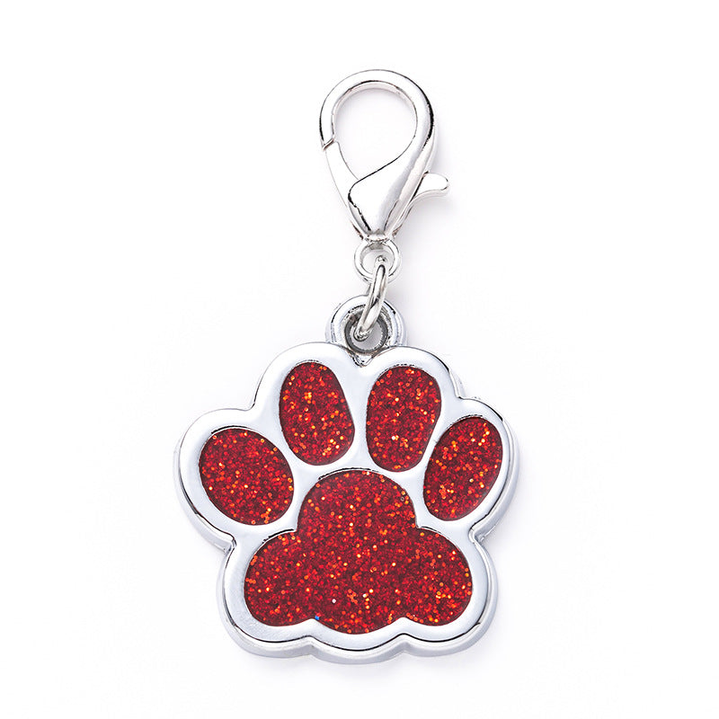 Red glitter paw print charm on a white background