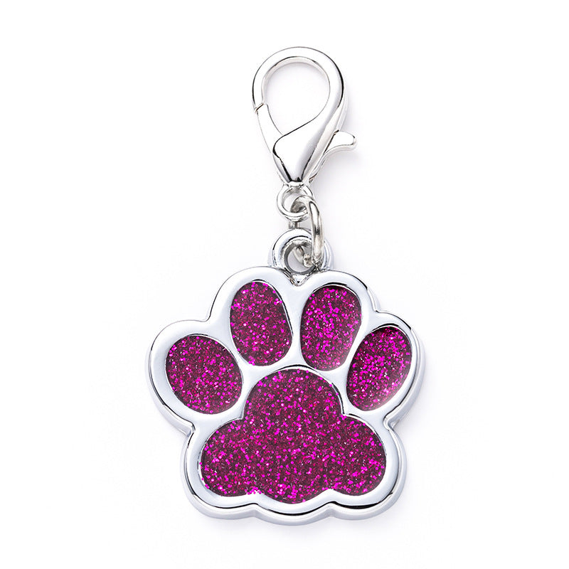 Pink glittery paw print charm with silver clasp on a white background