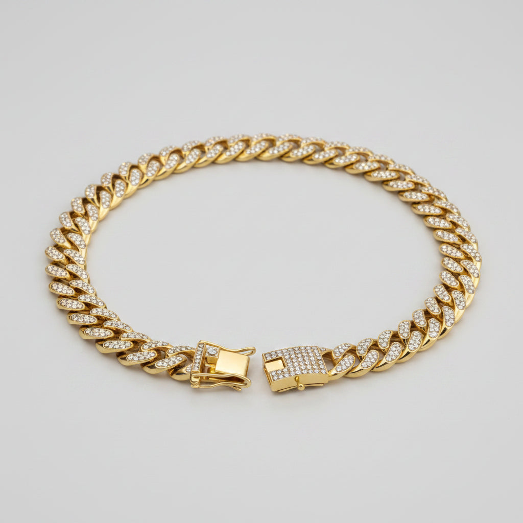 Gold chain bracelet with clear stones on a white background