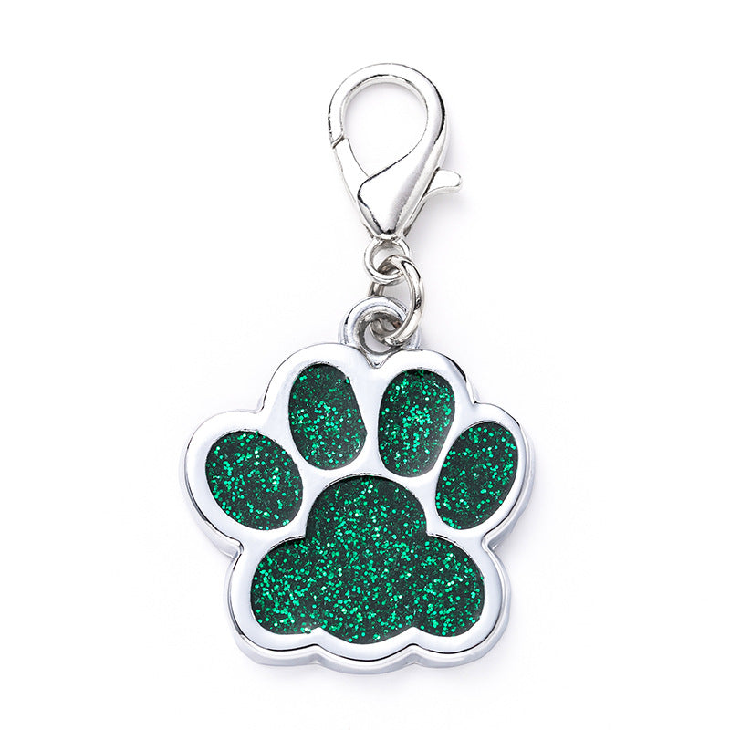 Green glitter paw print charm with a clasp on a white background