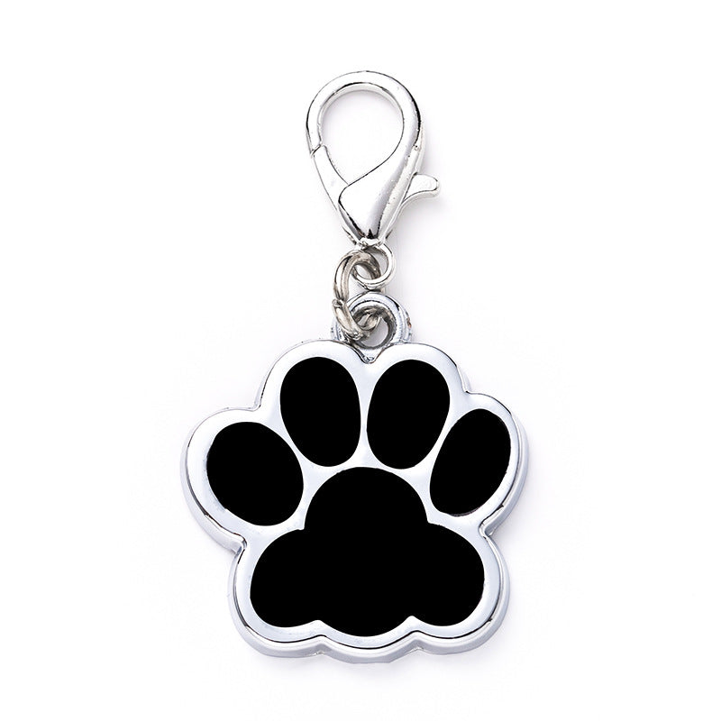 Paw print charm with a clasp on a white background